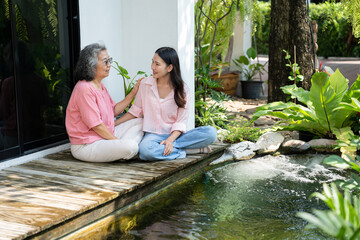 Daughter and elderly mother share a heartfelt moment together, strengthening their family bond. Caring caregiver, she offers love and support, highlighting their relationship and the beauty of sharing