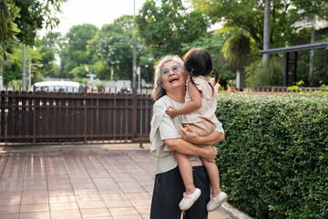 A cheerful grandmother embraces her granddaughter in the home, sharing a special moment. Their bond reflects love, care, and cherished memories, celebrating family joy and the enjoyment of retirement