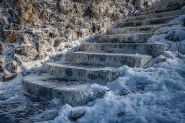 Fototapeta premium High Dynamic Range image of icy rocks during the cold season. rock formation and textured backdrop, natural, retro, snowy, masonry, pale, design, cyan, screen background