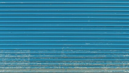 Fototapeta premium Detailed outdoor shot of a section of a blue metal barrier featuring a ventilation pattern.