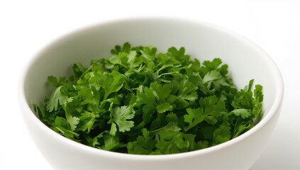 Fototapeta premium Bowl filled with chopped fresh parsley leaves on a white background