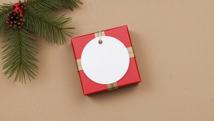 Blank circular holiday gift tag mockup alongside a red wrapped present, product label template featuring natural pine branches, cones, and festive decorations, holiday discount theme