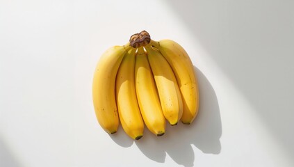 Yellow bananas arranged against a plain white backdrop