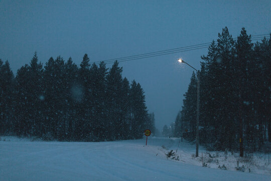 Idyllic view of footpath covered in snow at night