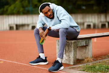 Athlete relaxing on running track after intense training