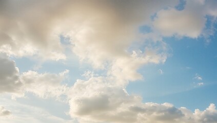 Obraz premium Puffy white clouds against a bright blue sky