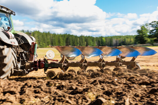 Tractor working on field in sunlight
