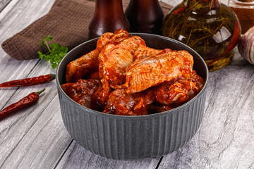 Raw marinated buffalo chicken wings