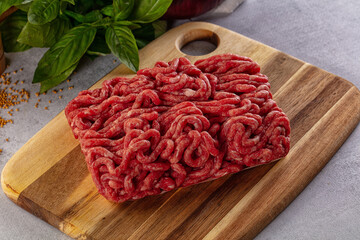 Raw minced beef meat over board