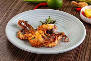Gourmet grilled whole octopus served lime