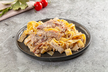 Italian pasta fettuccine with prosciutto