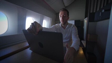 A Businessman Engaged in Work Inside a Luxurious Airplane Suite Designed for Comfort and Style