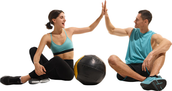 Fitness couple giving high five after workout with medicine ball on floor. Concept of teamwork, motivation, emotional support symbolizing wellness and positive lifestyle energy. Transparent background