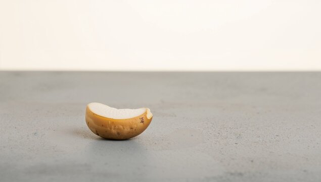 Cashew seed resting on a tiled background - accessory fruit (Anacardium occidentale)