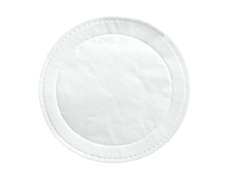 Circular, white cotton pad against a black background, featuring a stitched outer edge