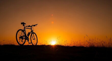 Obraz premium Silhouette of a bicycle against a vibrant sunset sky.
