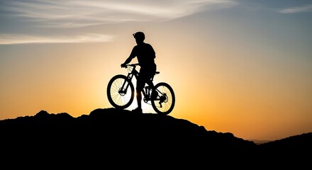 Obraz premium Silhouette of a cyclist on a mountain at sunset, enjoying the view.
