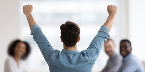 Person celebrating success with raised arms in front of smiling diverse colleagues in bright office, teamwork and leadership energy visible in moment