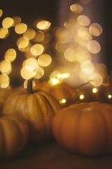 Pumpkins with blurred golden lights, cozy autumn mood, soft warm holiday background