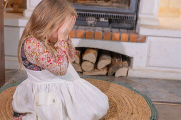 Little girl in folk dress crying with hands on face, Crying sensitive child, expressing deep childhood emotions and vulnerability, domestic violence, moment sadness and frustration in young life
