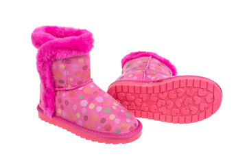 Adorable pair of pink polka dot winter boots for girls with cozy faux fur trim. Fun and warm children's footwear for cold weather, isolated on a white background.