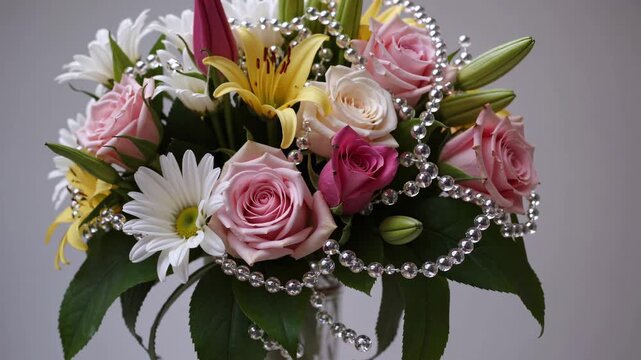 Explore how to create a stunning floral arrangement featuring pink roses, white daisies, and yellow lilies. This colorful display is perfect for any occasion and adds charm to any space