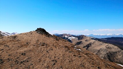Majestic mountain range panning shot under blue sky. Media