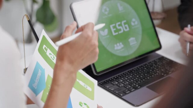 Collaborative esg strategy meeting corporate office presentation materials professional environment close-up view sustainability concepts