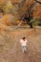 Family Walking With Pet Golden Retriever Dog Along Autumn Woodland Path Together