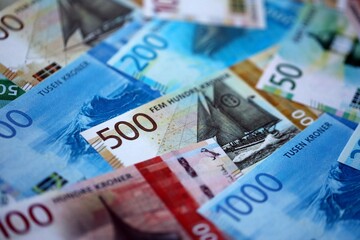 Norwegian Krone currency money bills. NOK currency banknotes in stack with different denomination close up