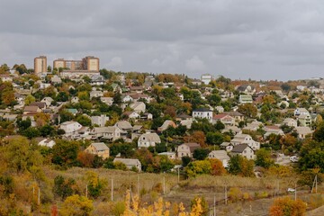 Family Walking With Pet Golden Retriever Dog Along Autumn Woodland Path Together