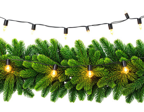 Festive garland of evergreen branches adorned with glowing string lights on black