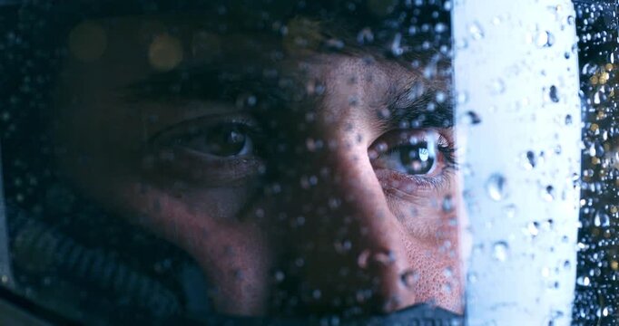 Slow Motion Close-Up of Racer Eyes Behind Wet Helmet Visor . Determination, Focus and Rain Reflections on Motorcycle Helmet at 1000 fps
