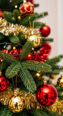 Fototapeta premium Decorated Christmas tree with red and gold ornaments. Festive holiday background with tinsel and baubles for the winter season. New Year celebration concept
