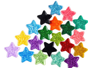 A cluster of star-shaped, multicolored, glittery objects against a solid black background