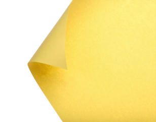 A close-up of a folded yellow paper corner against a stark black backdrop