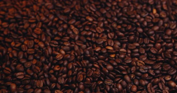 Above, spinning and roasted beans for coffee production, sustainable granules and aroma development. Motion, caffeine and fresh brew with bold taste, rich flavor and supply chain process for espresso