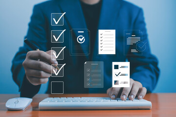 Businessman working on computer with virtual checklist documents icons, symbolizing task management, productivity planning, workflow optimization, and digital project organization in modern business.
