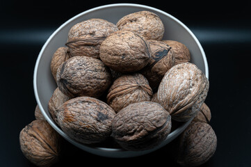 A composition of typically autumnal fruits such as walnuts, enhancing their beauty and detail.