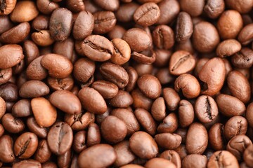 Textured background of freshly roasted coffee beans close up