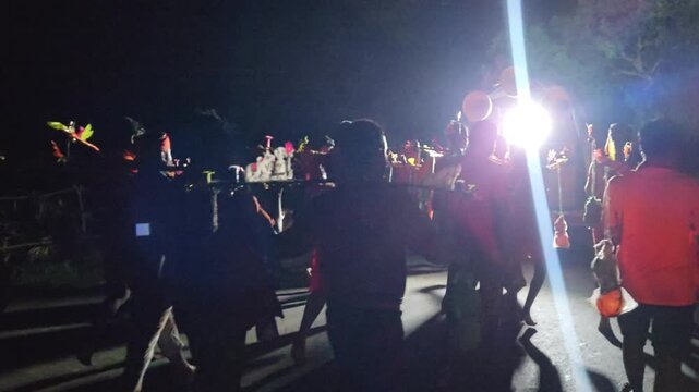 Authentic nighttime footage of Kanwariya devotees joyfully dancing while carrying decorated Kanwars Kawads during the sacred Kanwar Yatra in the holy month of Shravan Sawan, India.