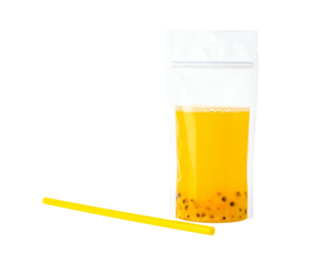 A filled, upright transparent pouch of yellow drink with a straw lying near it