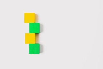 Four Wooden Cubes in Vertical Zigzag on White