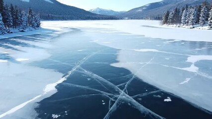 High aerial view slowly rotating above a frozen lake displaying intricate geometric ice cracks and patterns during winter winter, cracks, tranquil - Powered by Adobe