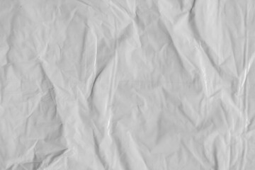 Plastic texture with wrinkles and folds, isolated transparent background. Crumpled synthetic...