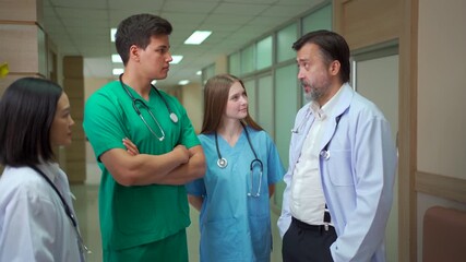 Multinational medical team discussing data on digital tablet in hospital. - Powered by Adobe