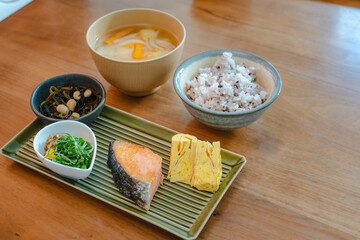 Traditional Japanese breakfast with grilled salmon and miso soup
