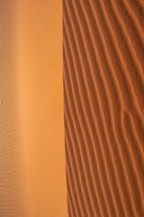 Merzouga, Morocco, Africa: close up and details of Erg Chebbi dunes, view of a dune in the Sahara desert, grains of sand forming small waves on the beautiful dunes at sunset 
