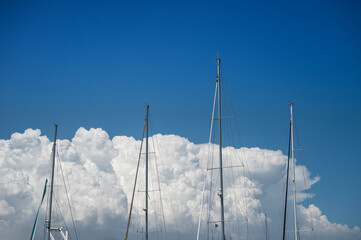 Sailboat Masts Against Cloudy Sky