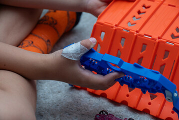 The child has a cut wound covered with a bandage